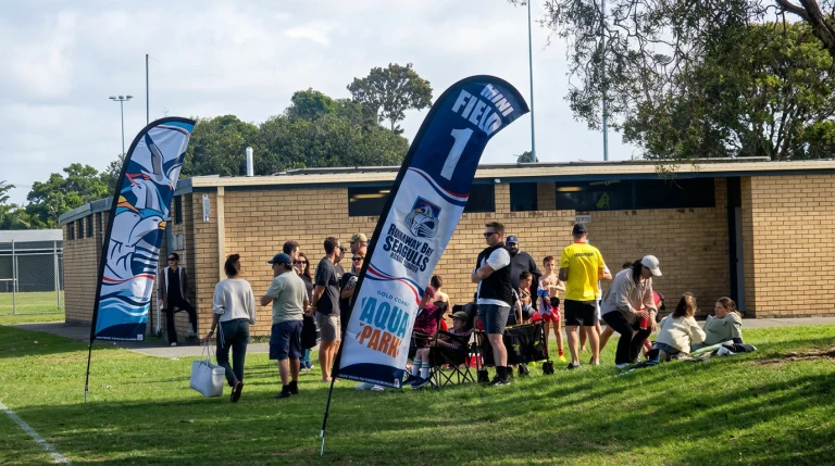 Feather flags installed at a local sports club event for soft signage visibility