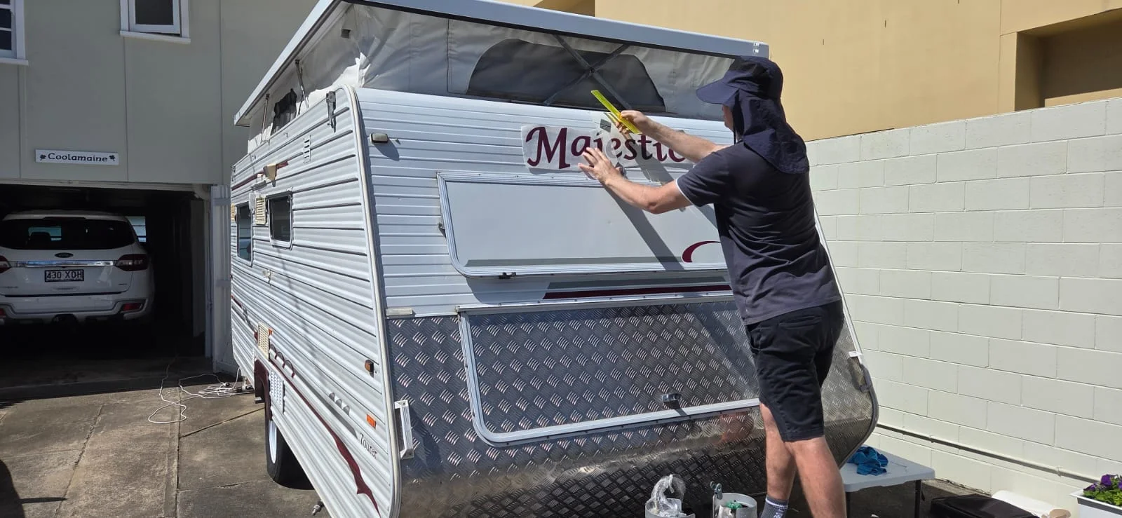 Original Majestic caravan lettering being carefully removed