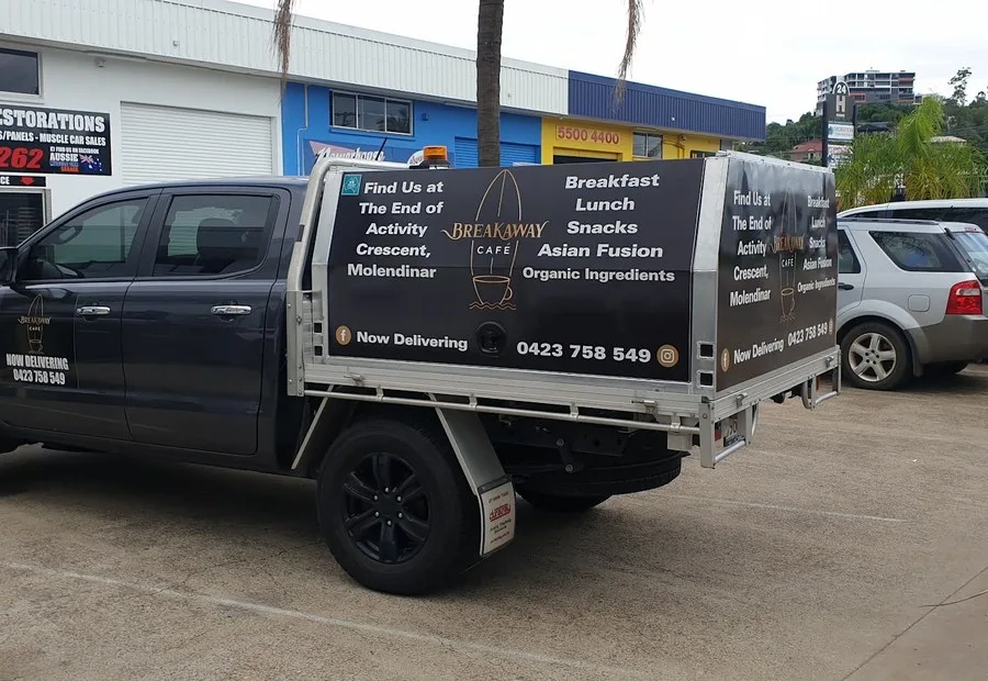 Breakaway Cafe black dual-cab ute wrap with tray canopy signage on the Gold Coast